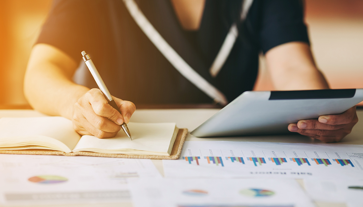 business woman surrounded by financial reports doing an analysis