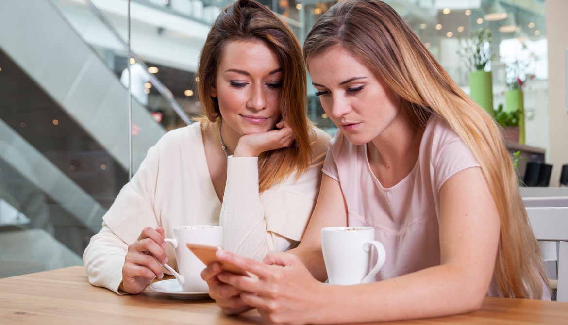 girlfriends paying the bill in coffee house like with Venmo