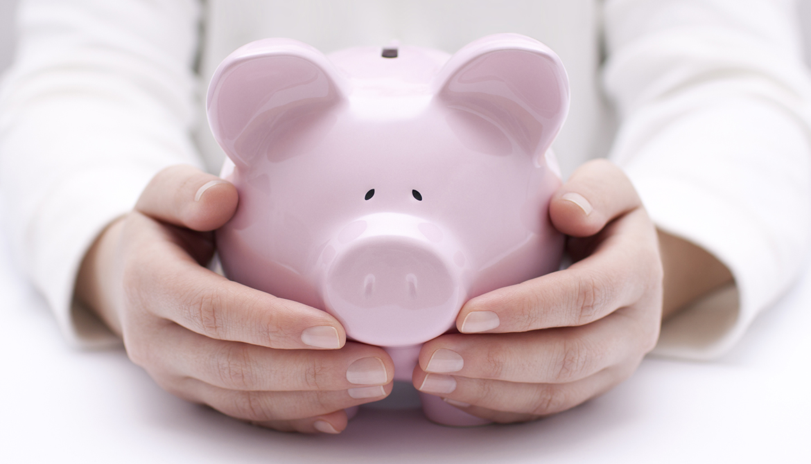 member hands protecting a piggy bank