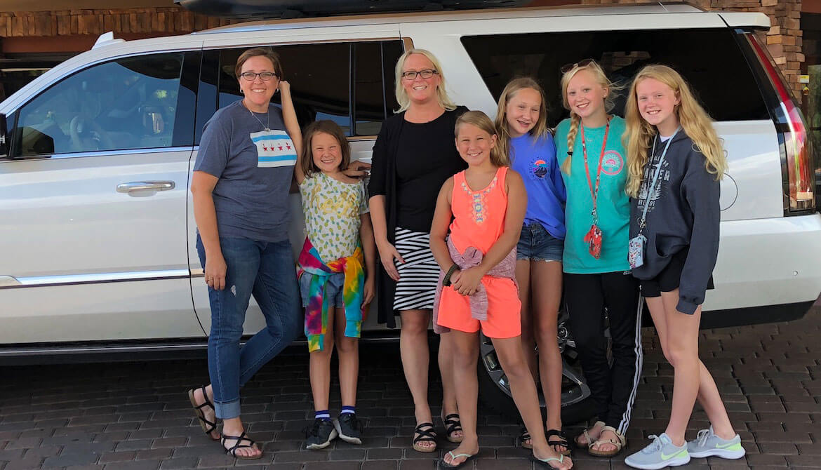 aughters demonstrating their buy-in in front of the car before leaving Sedona