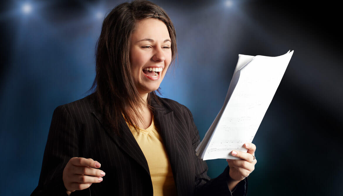 Girl singing a song with notes in her hand