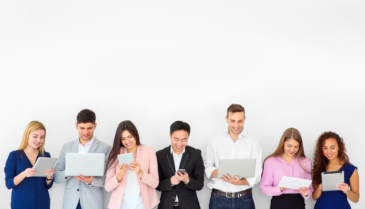 A row of young businesspeople all communicating via digital devices