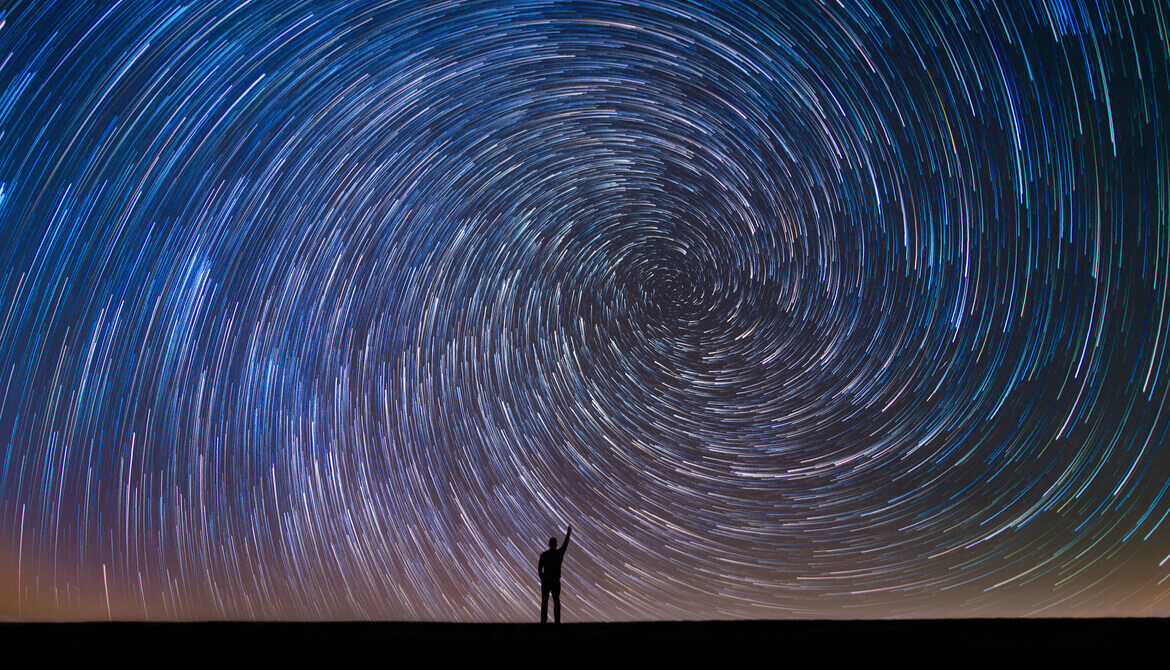 Man Pointing North in a spiral star trail