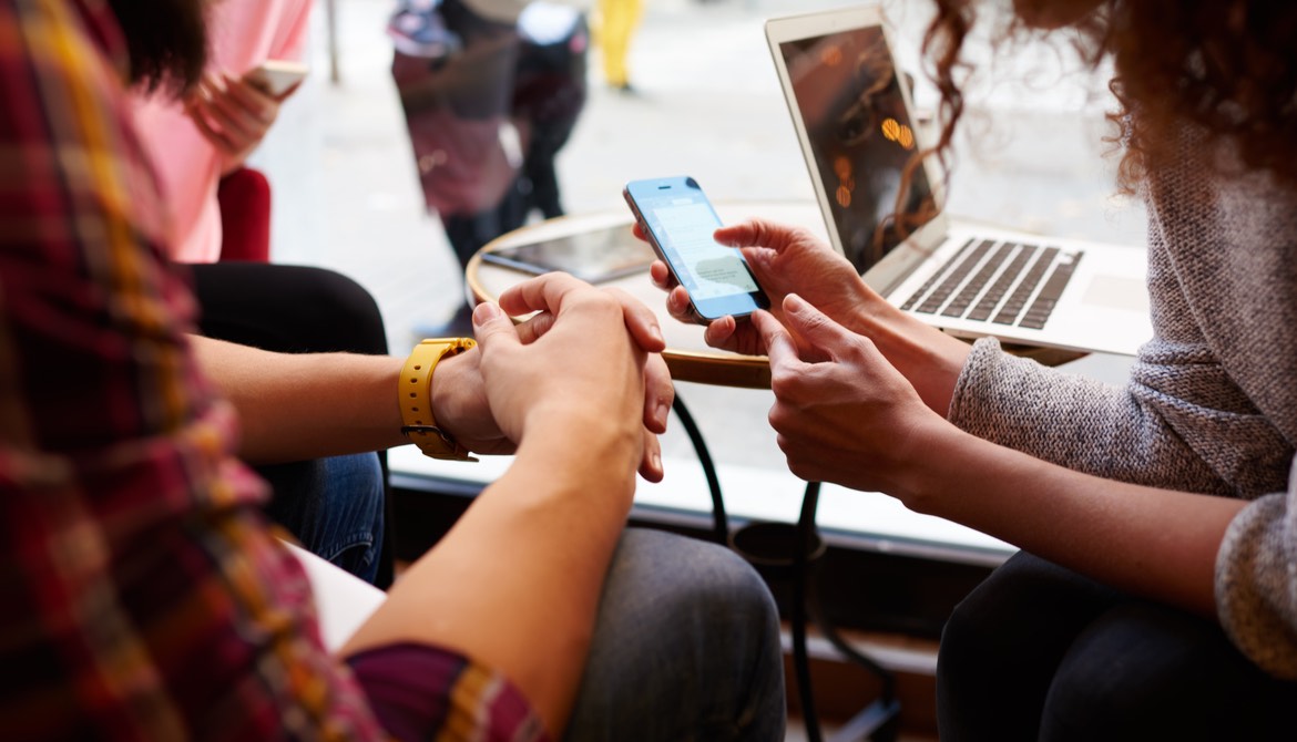 friends use an Apple phone to pay