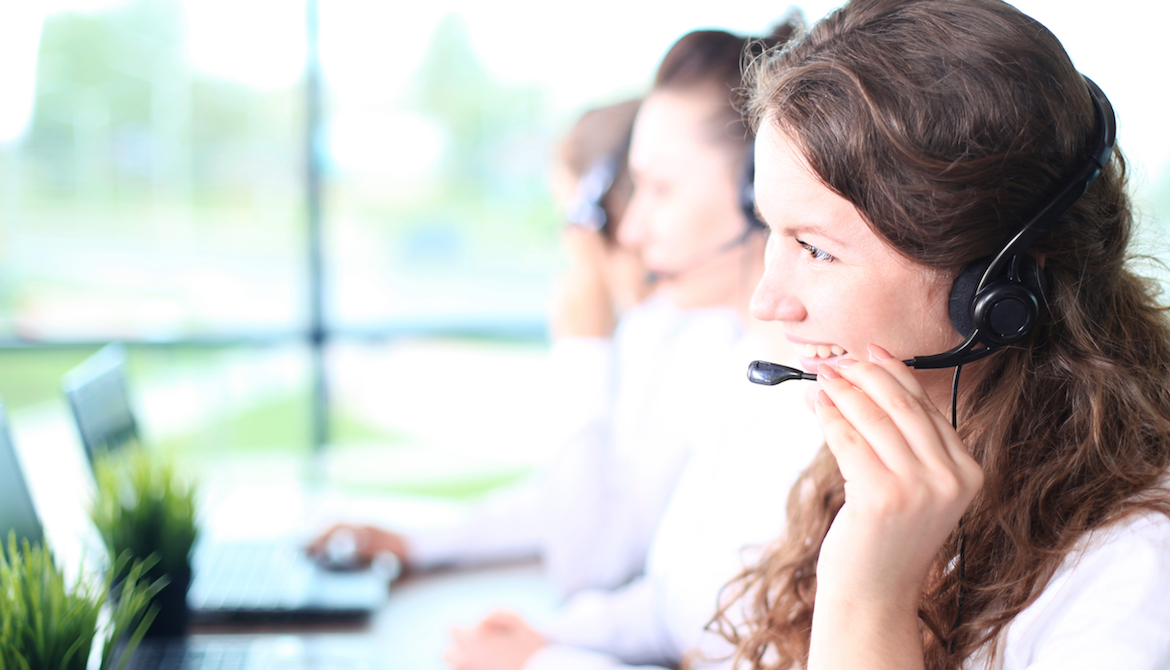 woman with headset on smiling