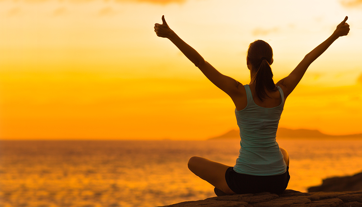 Healthy woman celebrating during a beautiful sunset Happy and Free Illustrates self-care balance and employee wellnesss