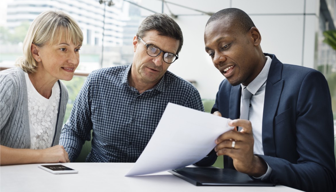 financial advisor reviews retirement plan with couple