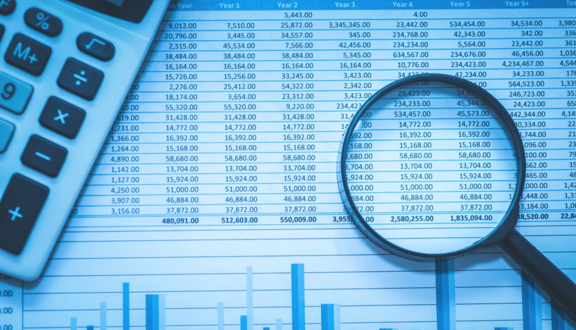 Spreadsheet bank accounts accounting with calculator and magnifying glass. 