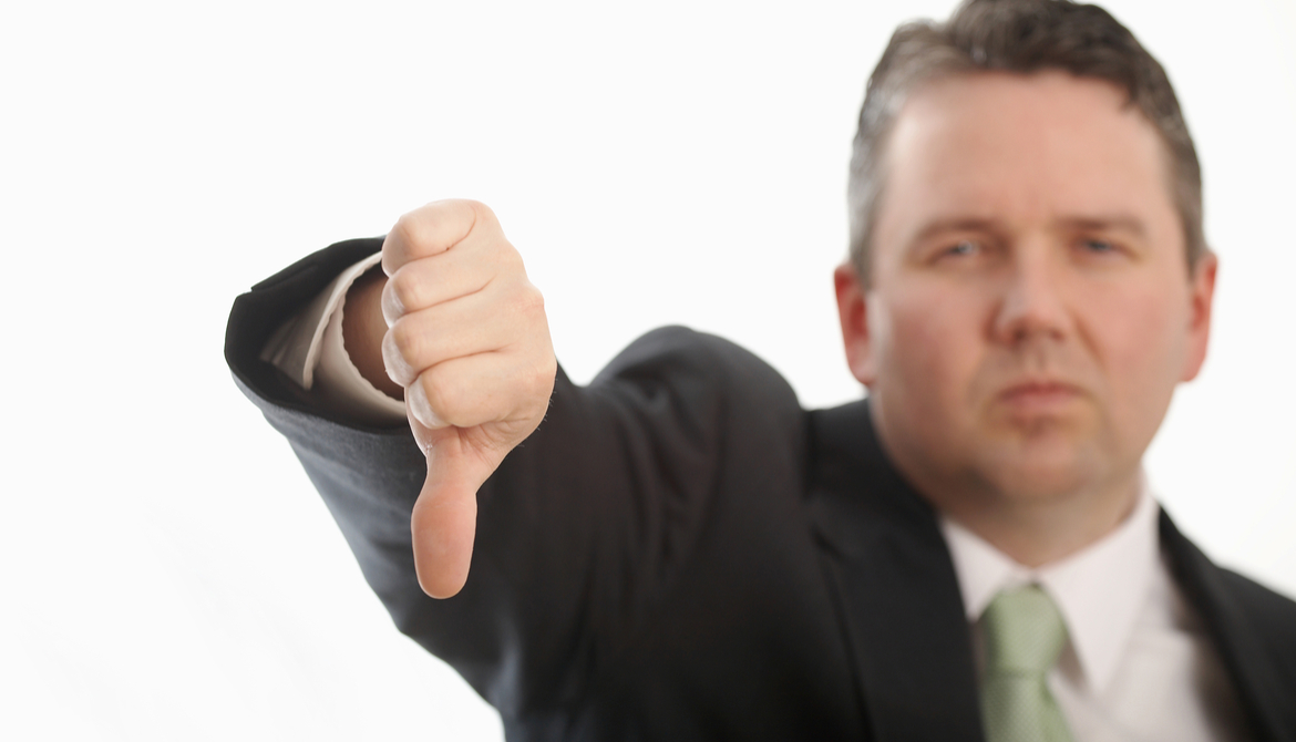 executive in green tie with thumb down