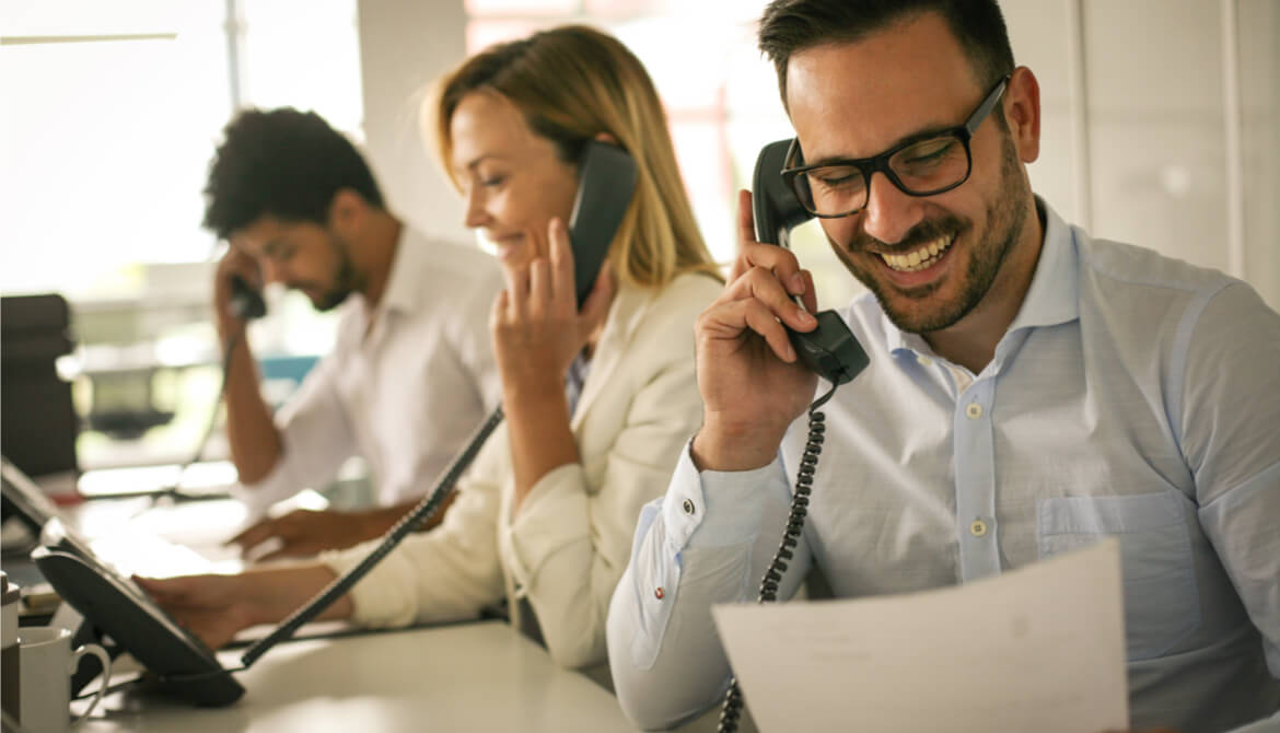 People in operations center talking on landline phone