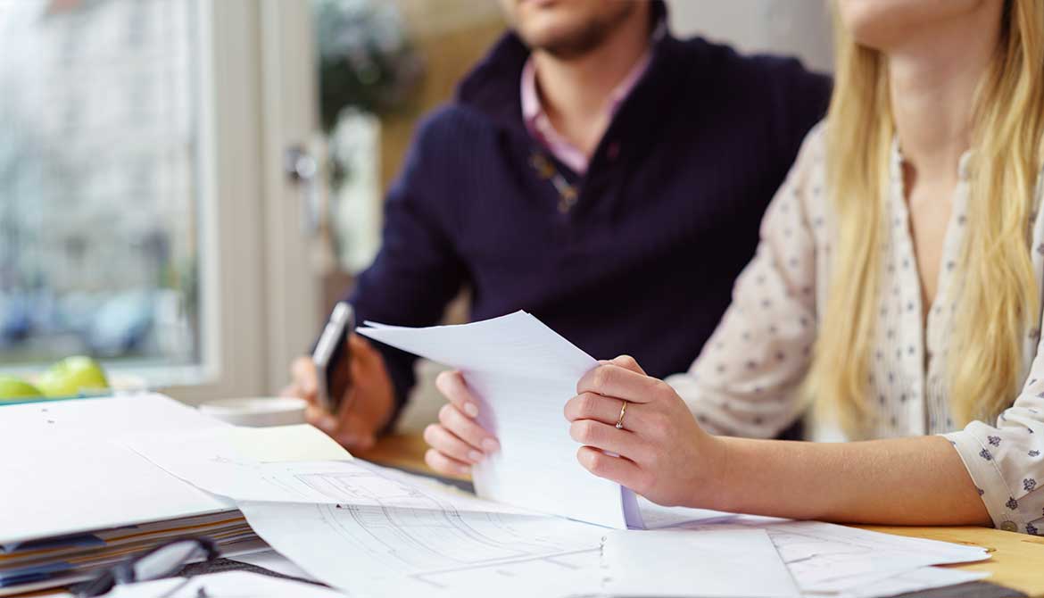 couple reading a contract in an office