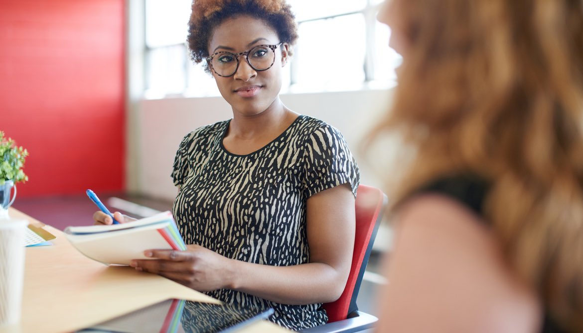 African American woman manager conducting interview with female employee