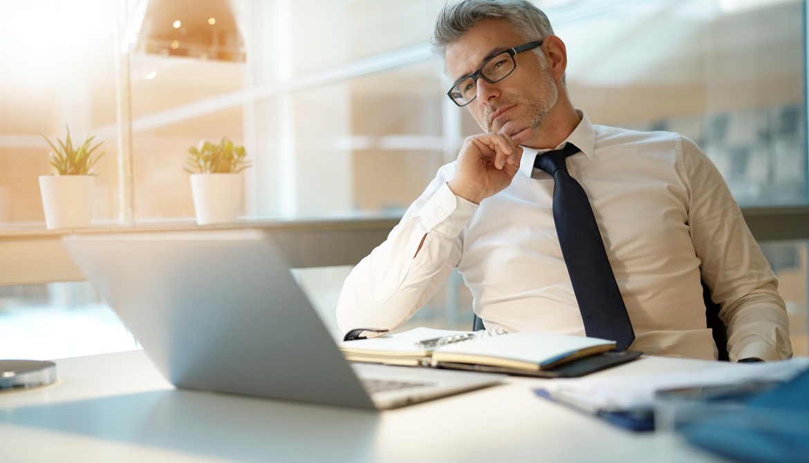 lender working with laptop, looking worried