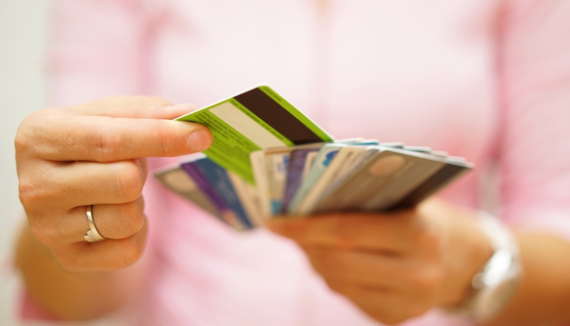 woman in pink choosing one card from a stack