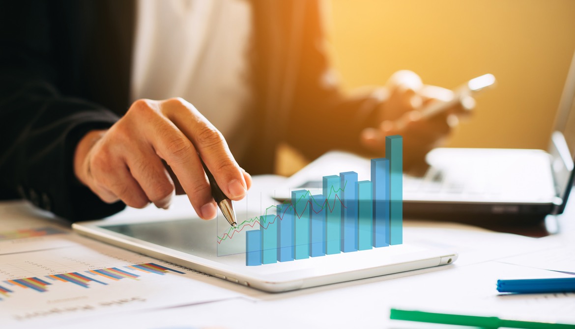 executive auditing with tablet displaying a 3-D chart