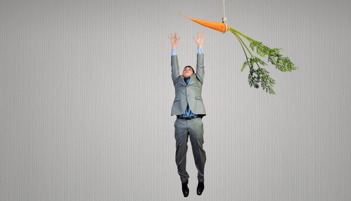 Funny image of businessman jumping for a carrot