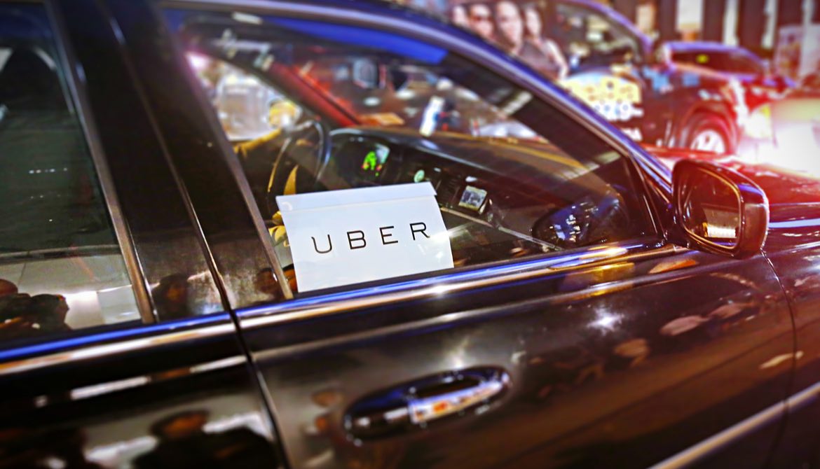 car with uber sign in window