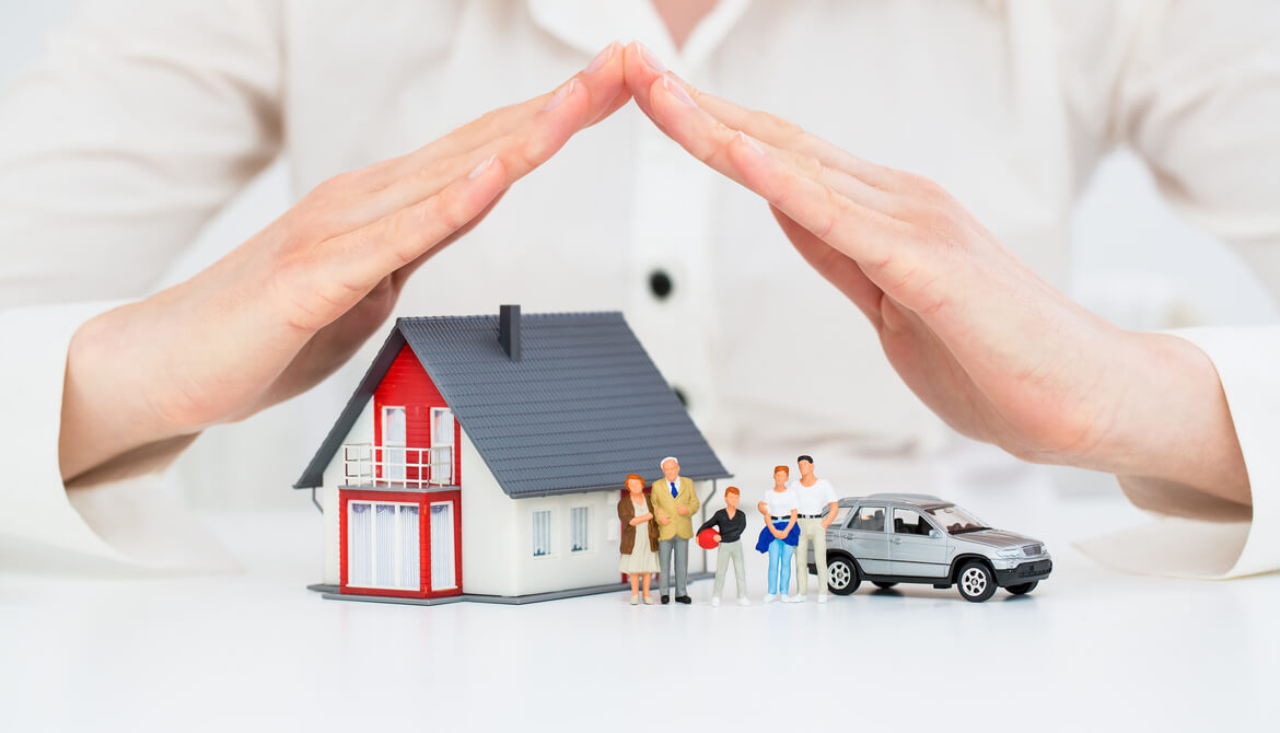 credit union insurance agent protects model house family and car with her hands