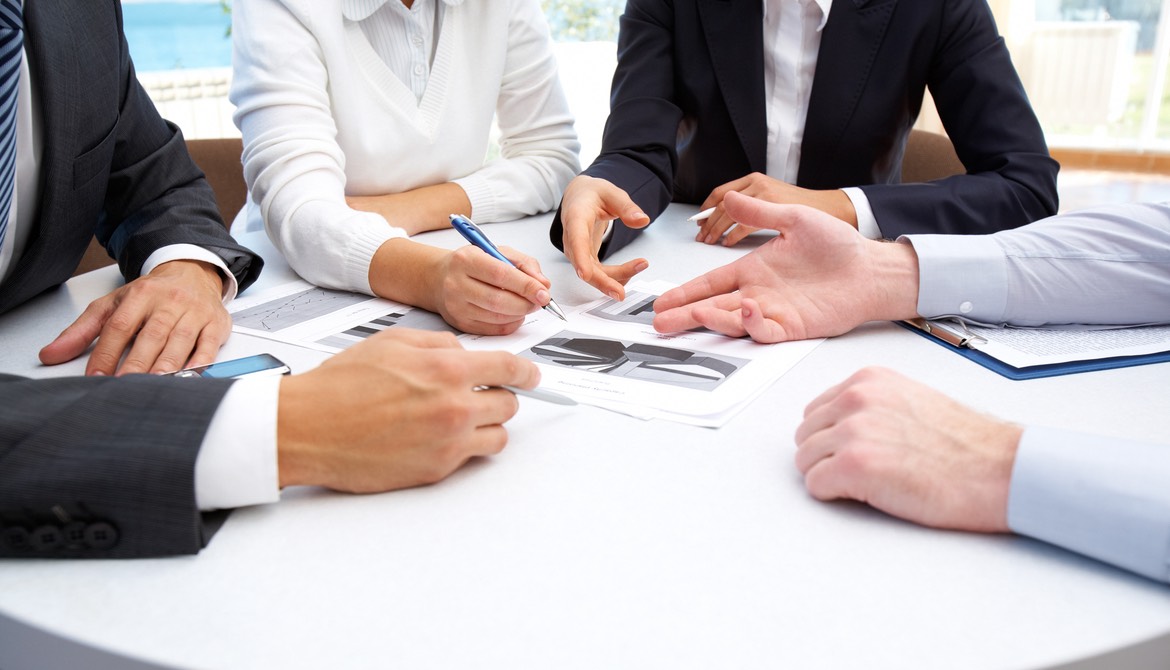 businesspeople reviewing and negotiating vendor contract