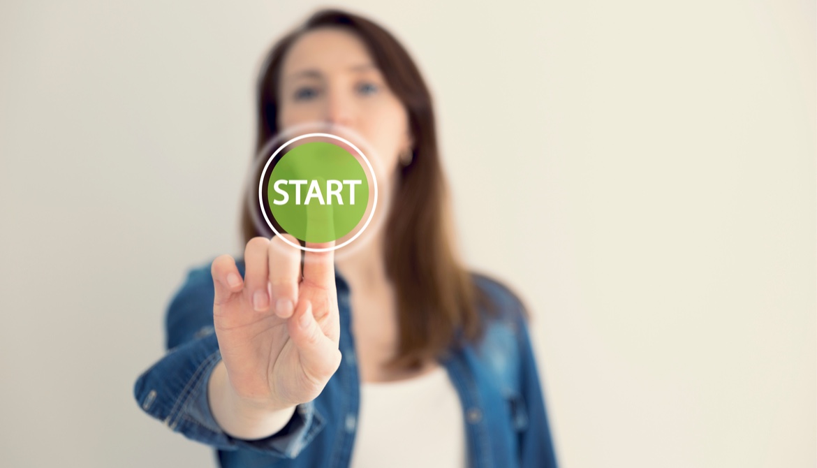 woman presses green start button