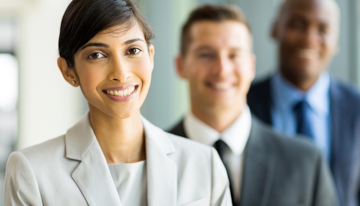 female executive from India with colleagues out of focus