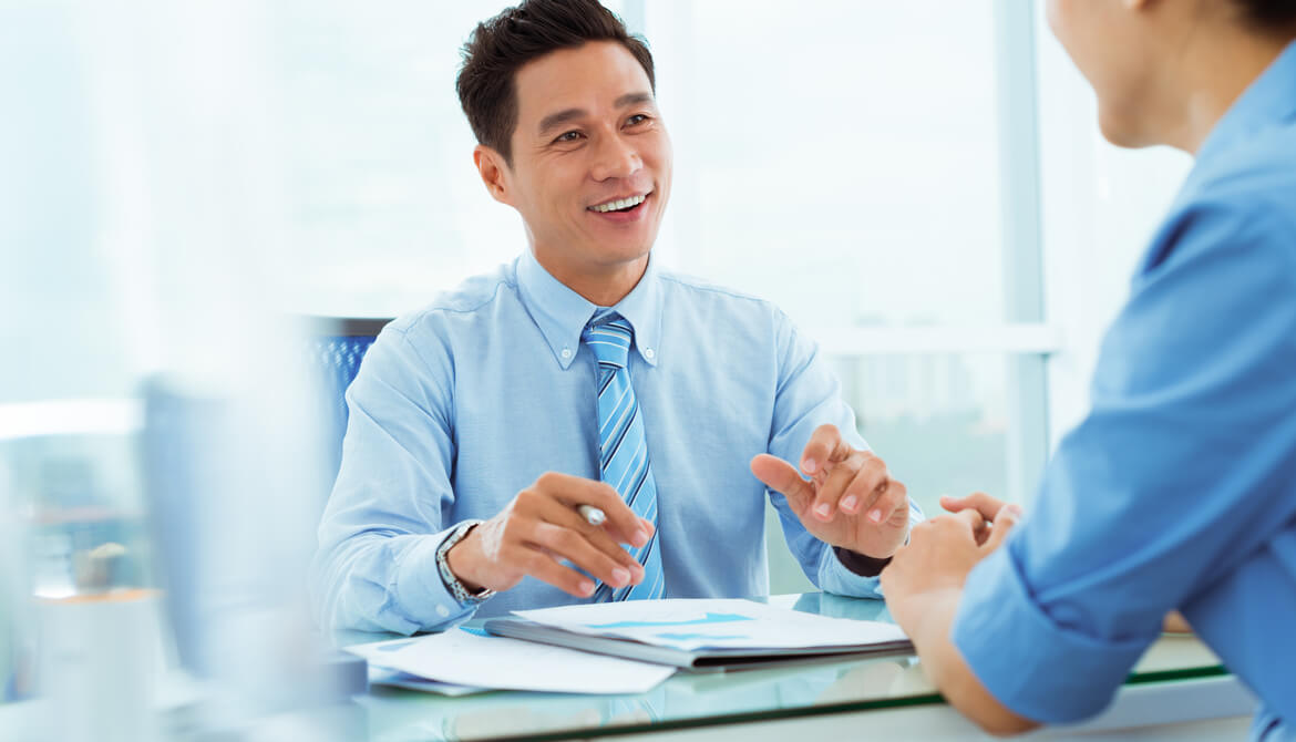 smiling engaged employee advises customer in office