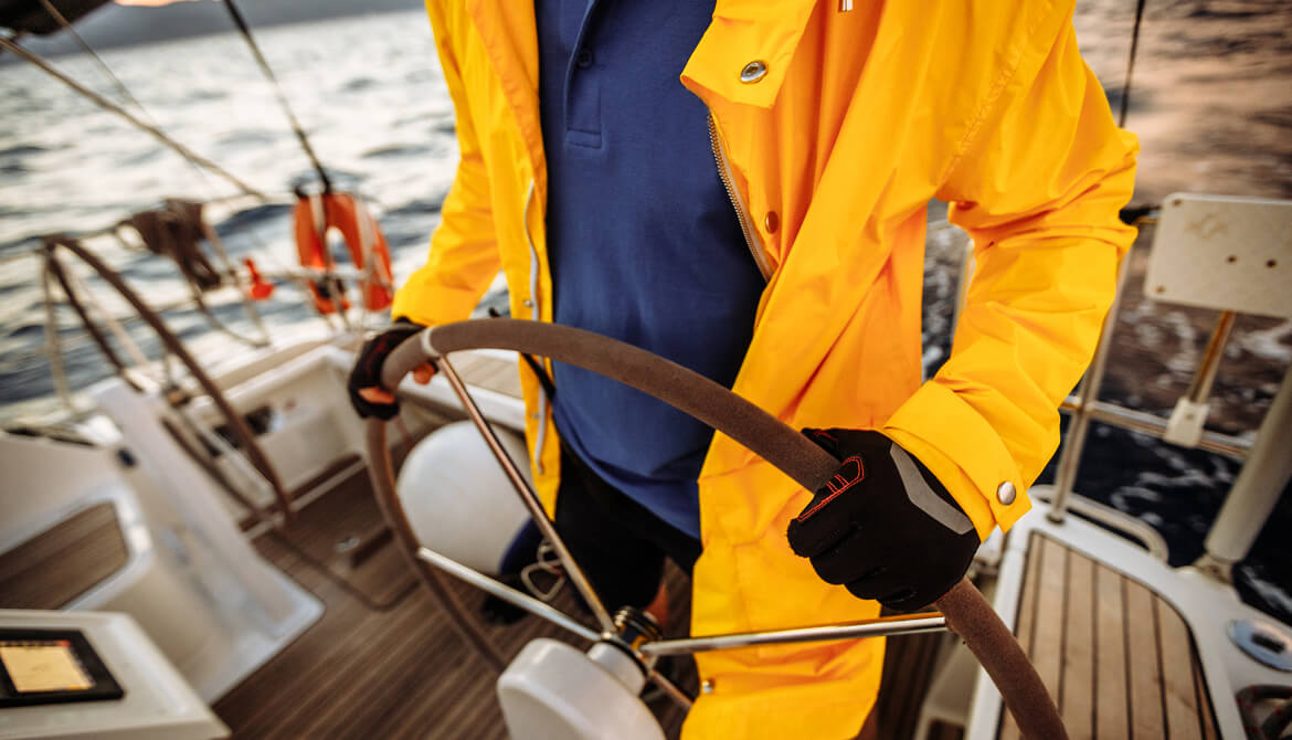 sport captain at the helm of a ship in the wind