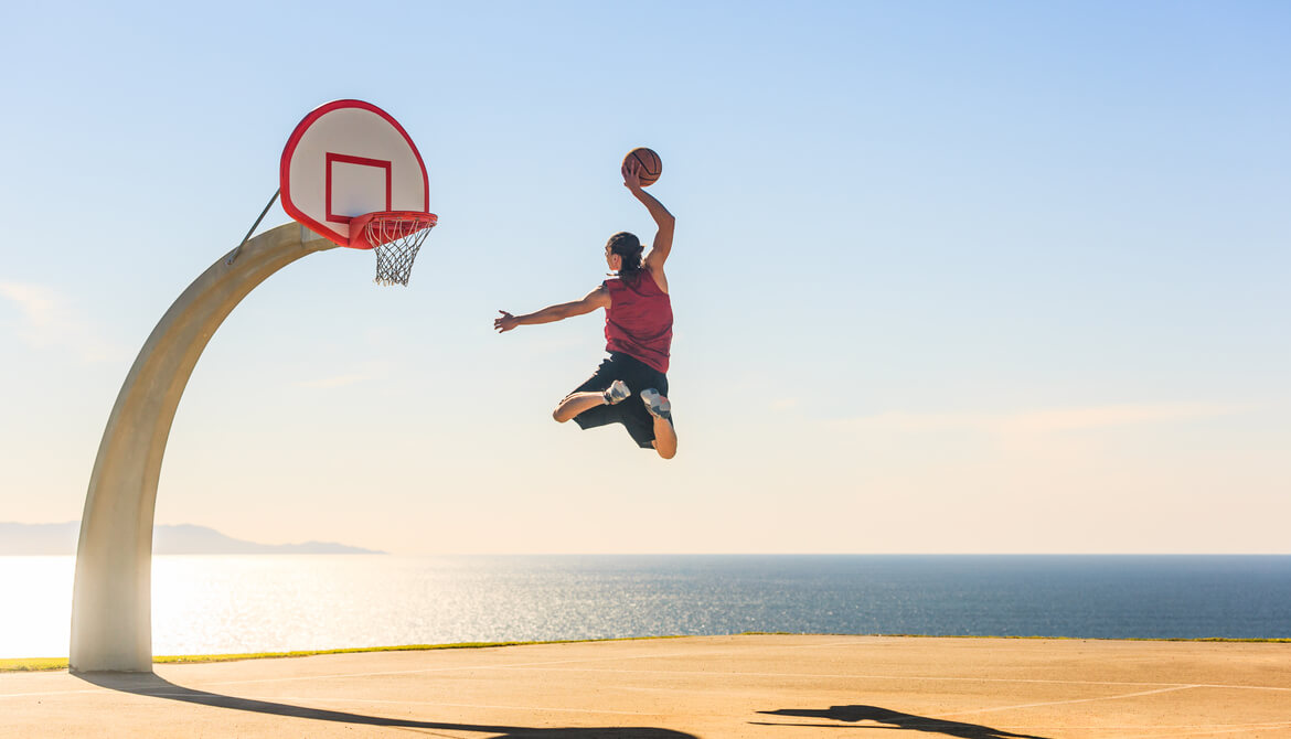 basketball player scoring amazing slam dunk