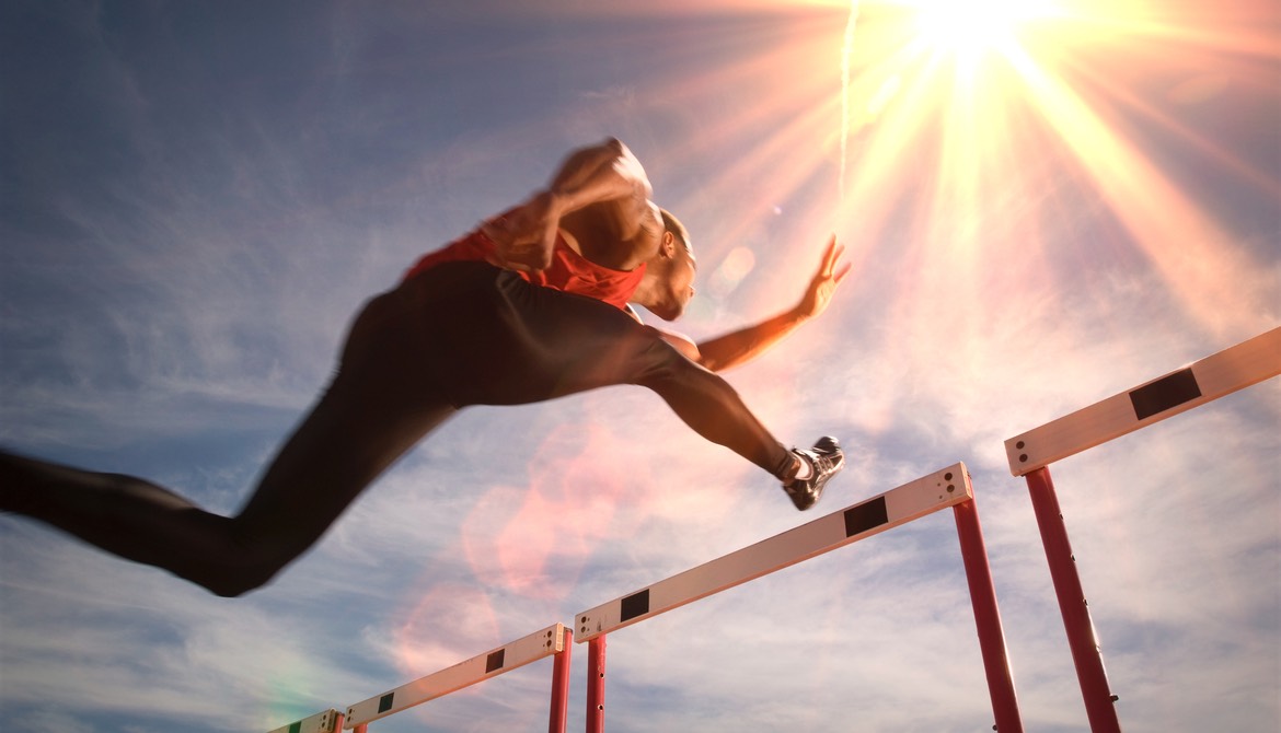 hurdler clears hurdle in the sun