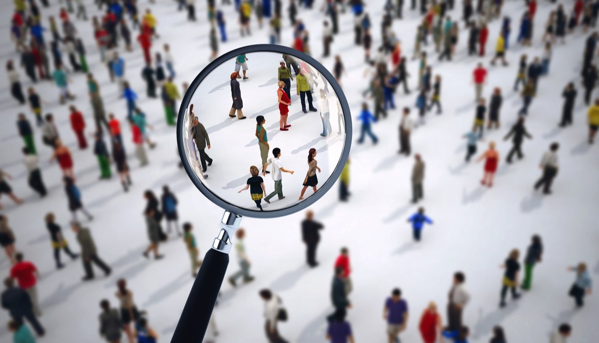 searching crowd of diverse people with magnifying glass for job candidate