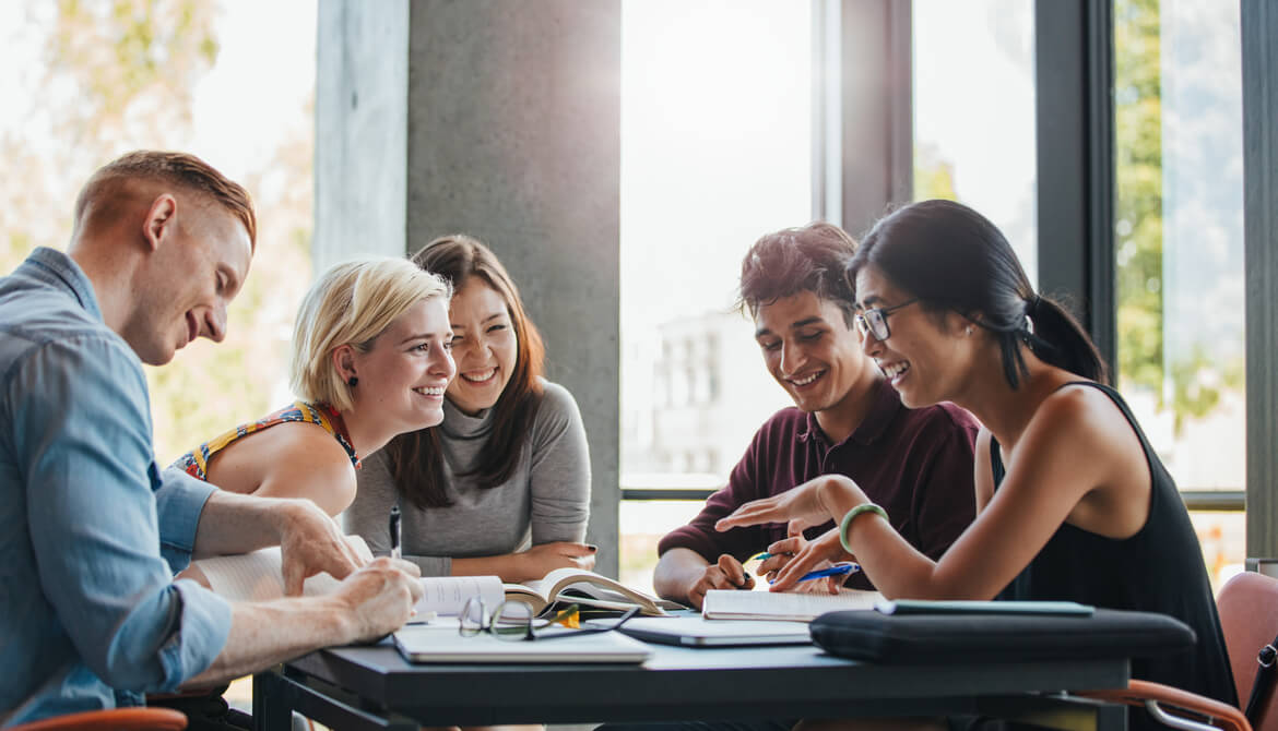 happy young students studying books