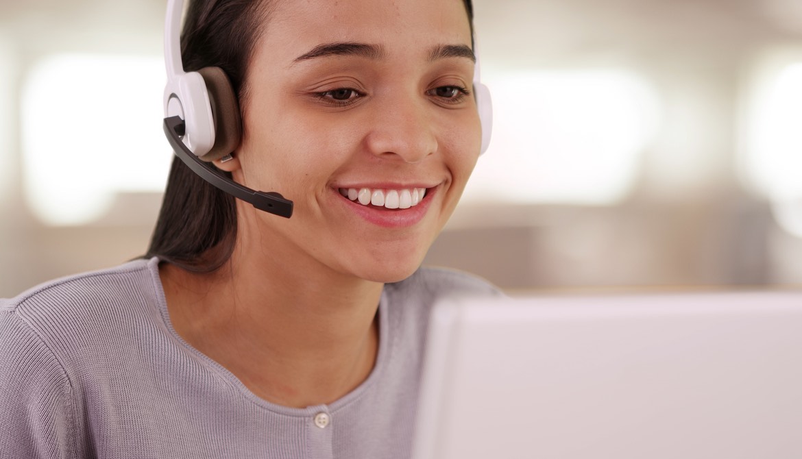 young female employee with headset and computer