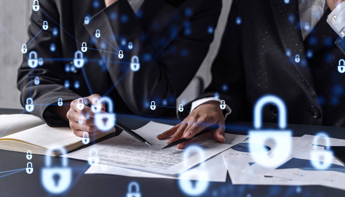 businesswomen working on documents at table with padlocks overtop