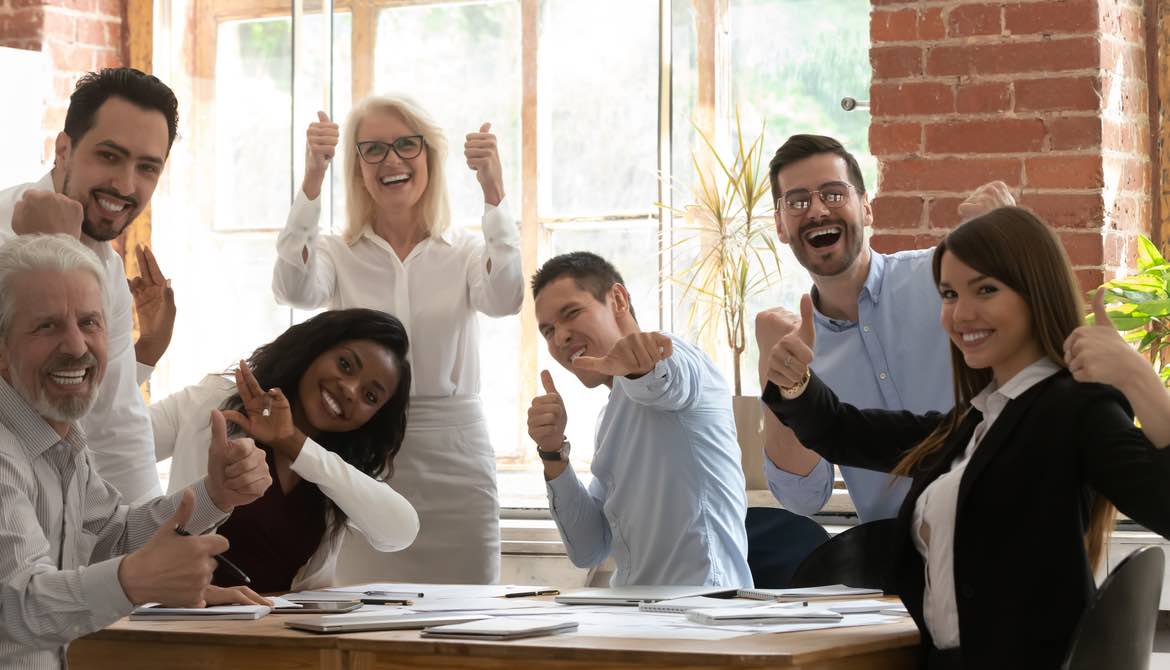 diverse executives with thumbs up