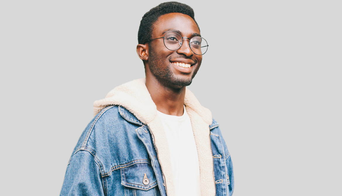 happy black gen z in jeans jacket and glasses