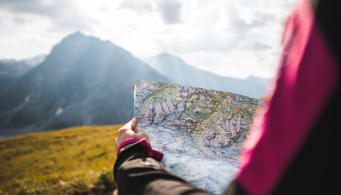 girl navigating mountains with topographic map