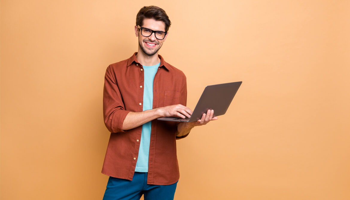 smiling man with laptop