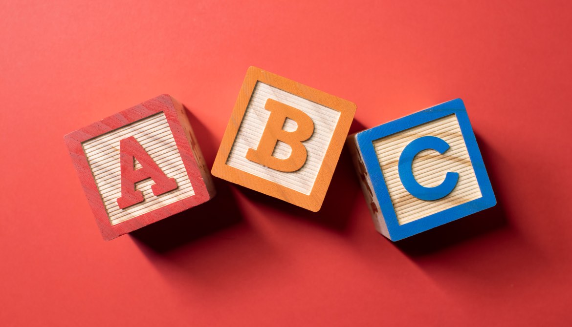 wooden alphabet blocks orange background