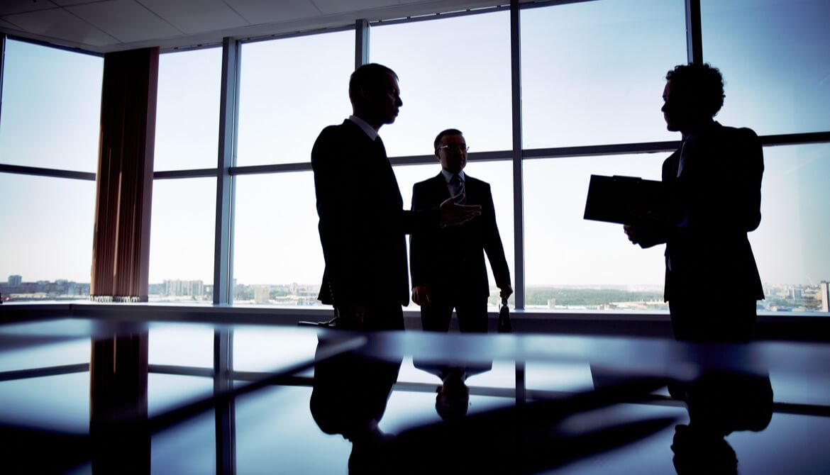 shady group of men in suits discussing business