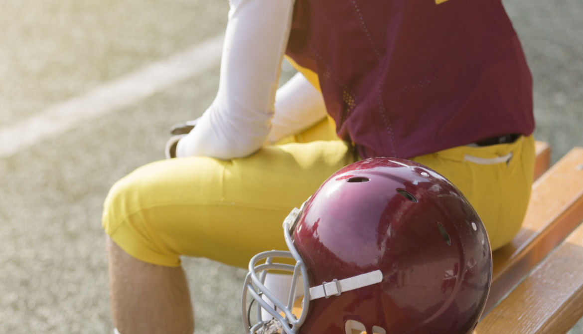 player with helmet on bench