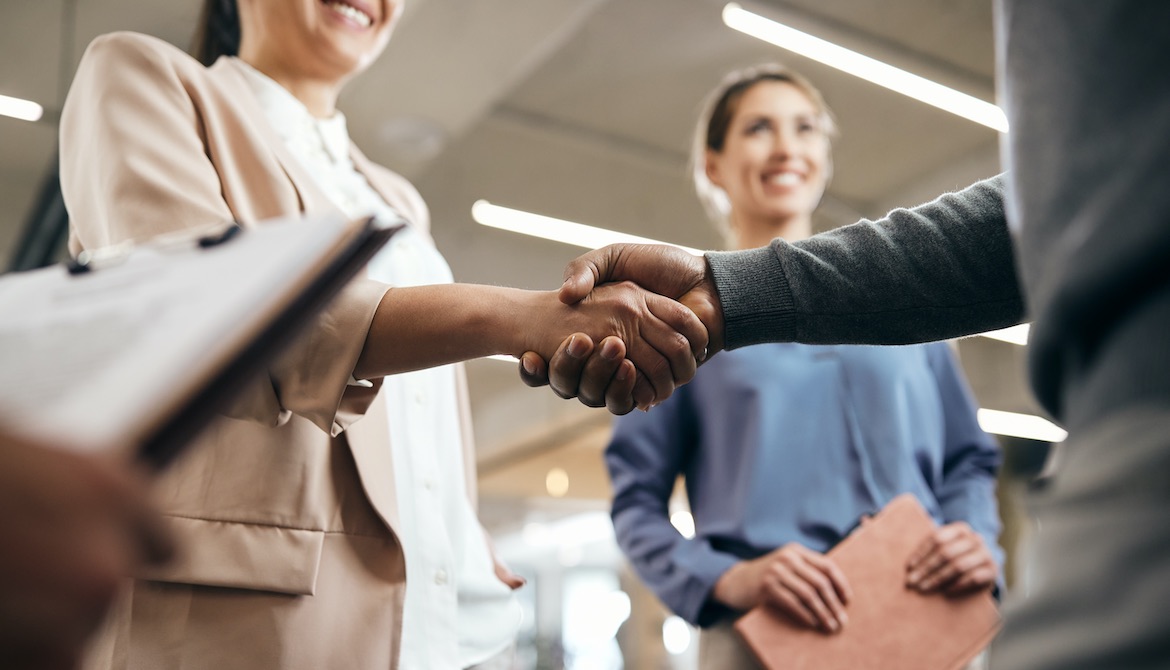 manager shaking hands and greeting new hires at the office