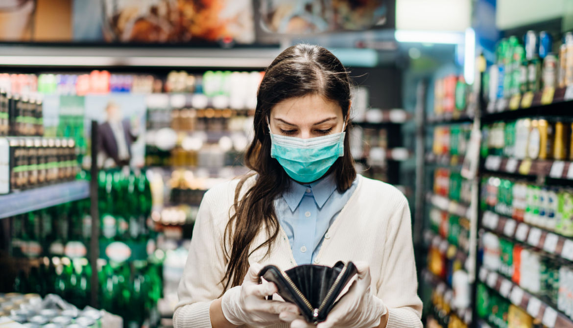 shopper with wallet in grocery aisle