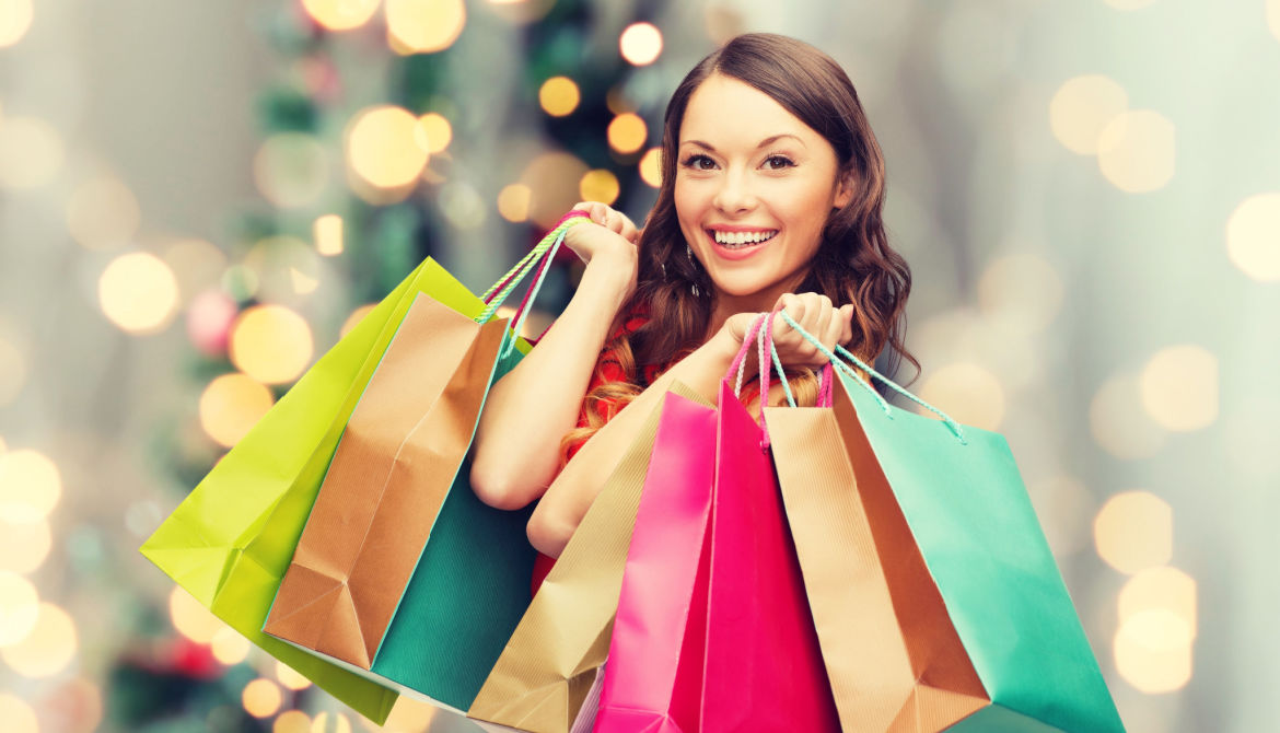 woman doing holiday shopping with colorful bags