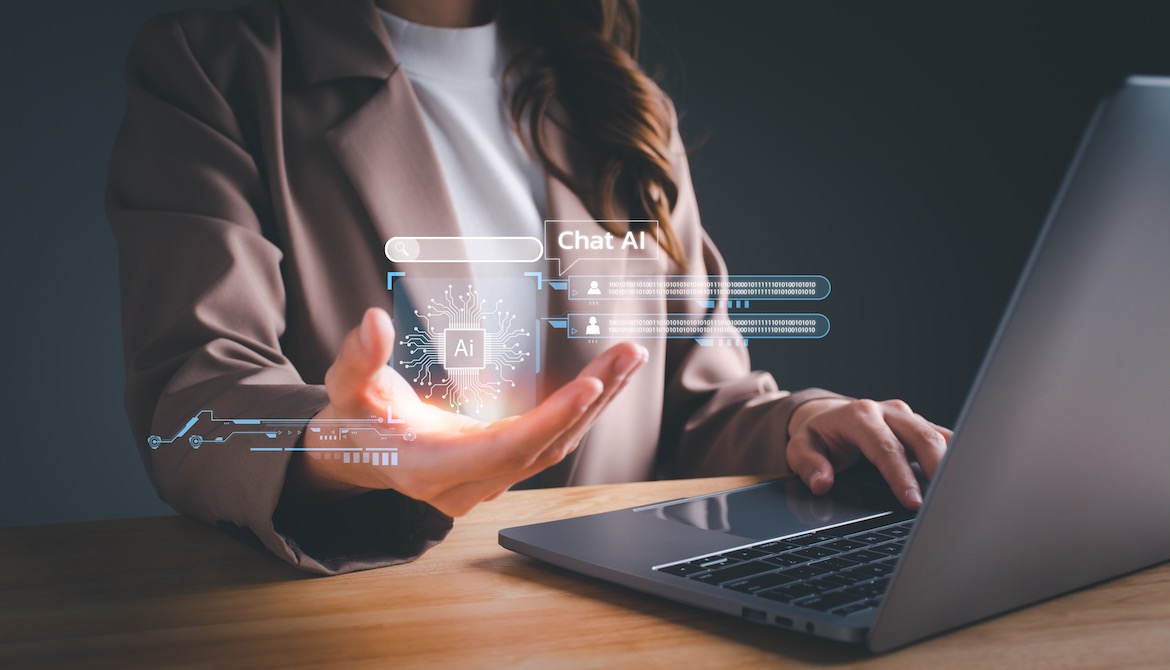 businesswoman using laptop holds digital artificial intelligence AI interface in hand