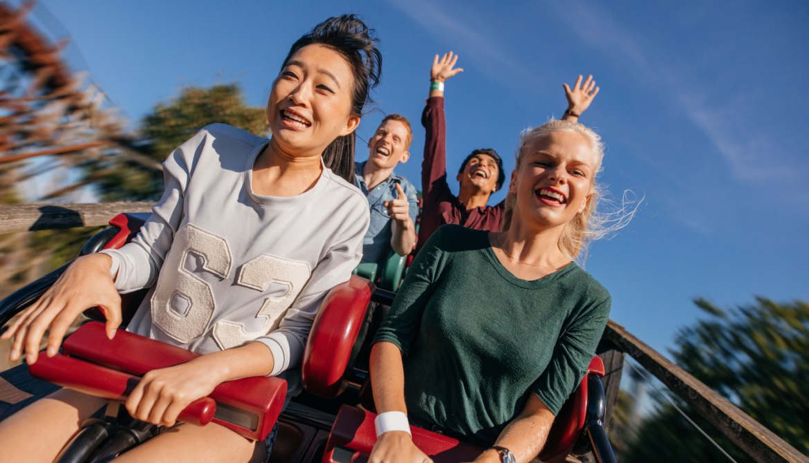 Young people on a thrilling roller coaster ride