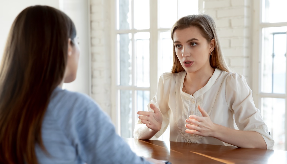 manager having serious conversation with employee at the office