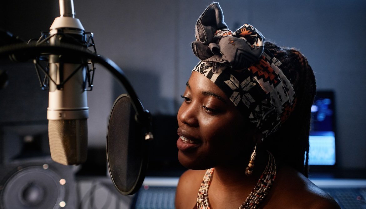 African American woman singing studio mic