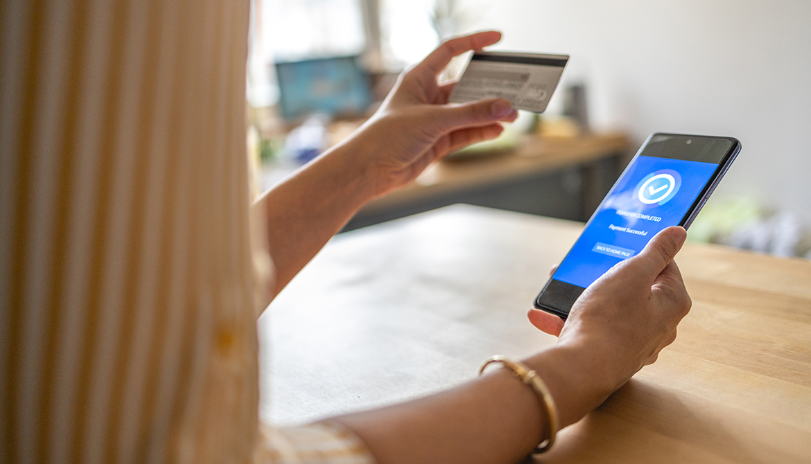 online shopping - hand holding credit card and cell phone