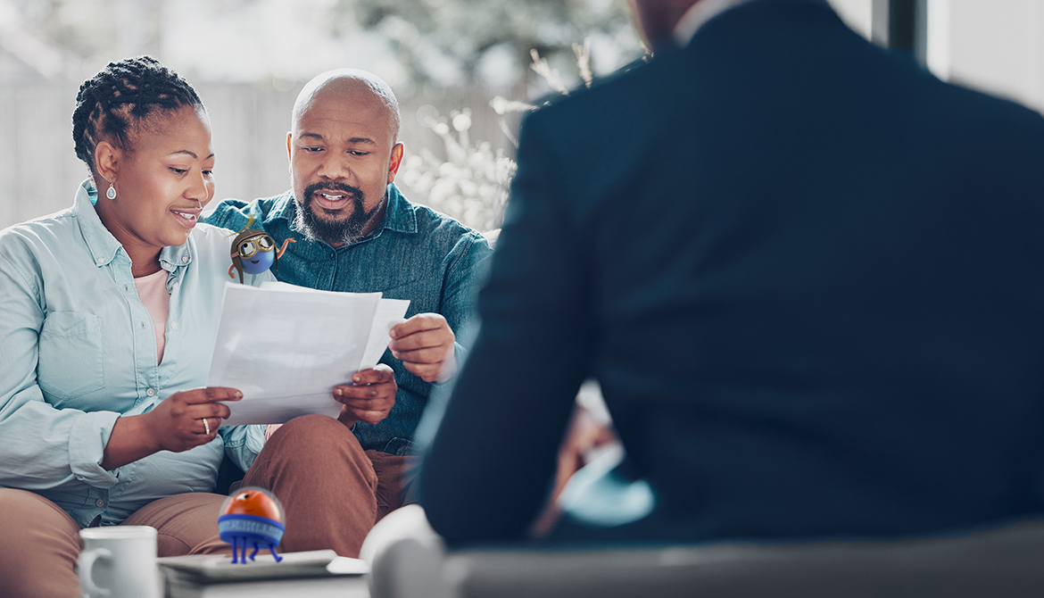 couple smiling looking over documents