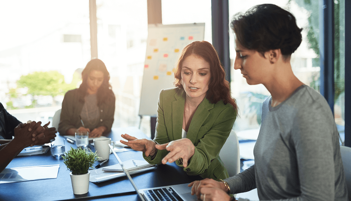 co-workers sitting at a table talking